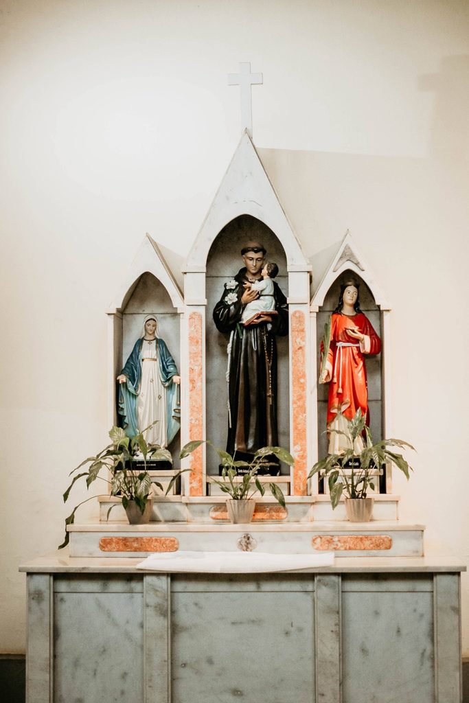 Statues of saints displayed inside a Catholic church